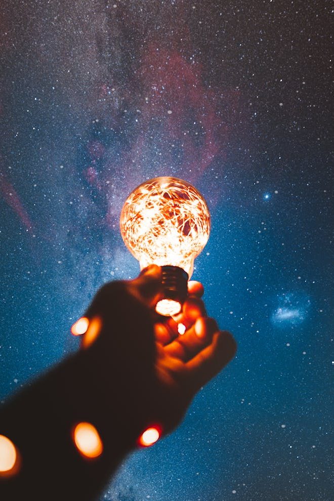 Person holding a light bulb